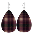 Front view of Falling for You faux-leather teardrop earrings in deep berry and charcoal-green plaid with tiny gold hearts.
