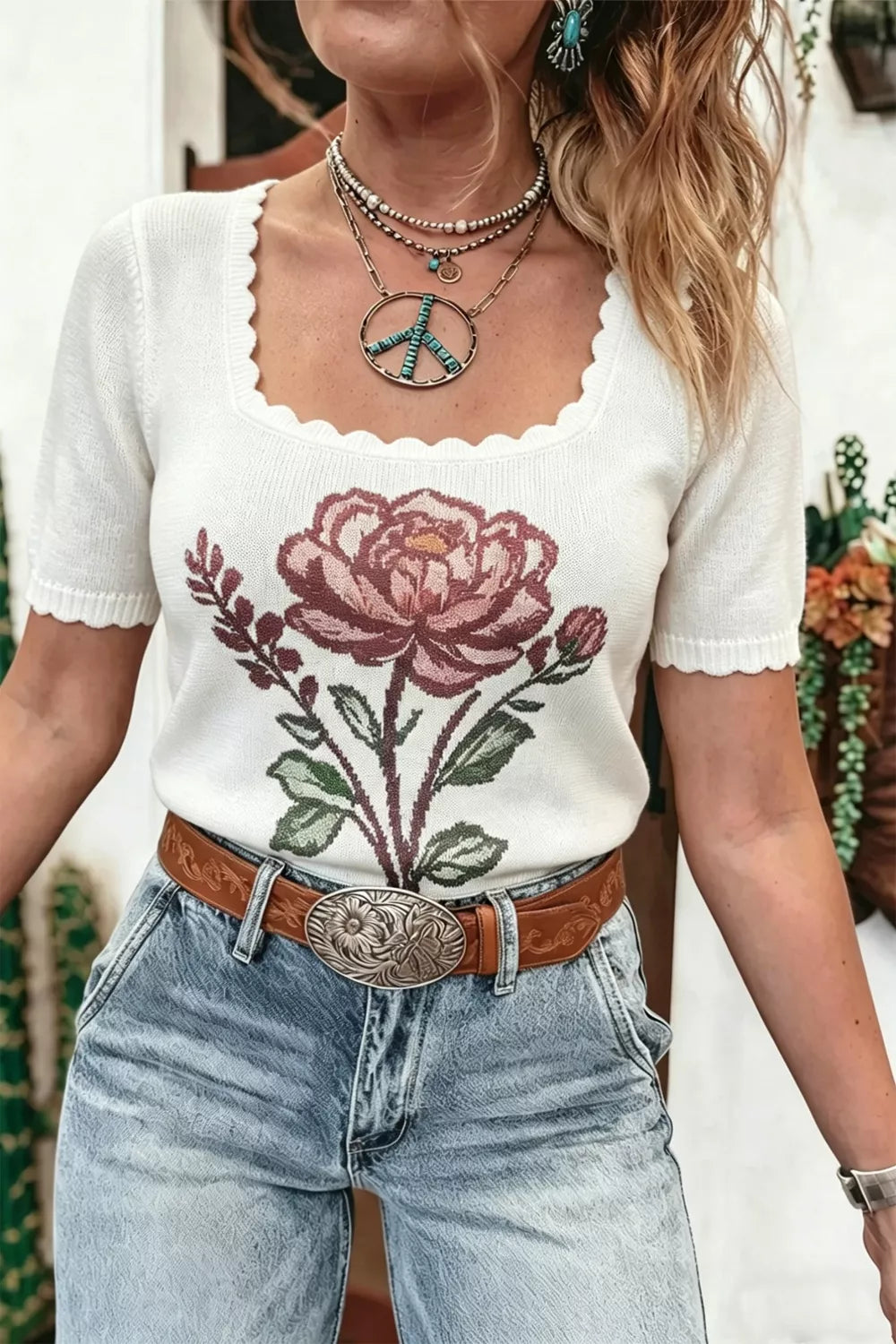Ivory scallop-edge knit top with a large rose motif