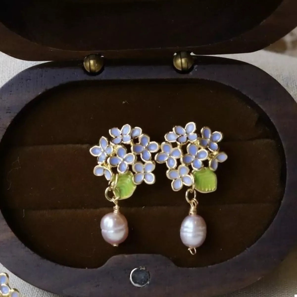 Blue hydrangea-inspired floral earrings with pearl drops
