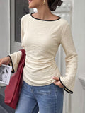Ecru long-sleeve blouse with black contrast trim and tie-back waist