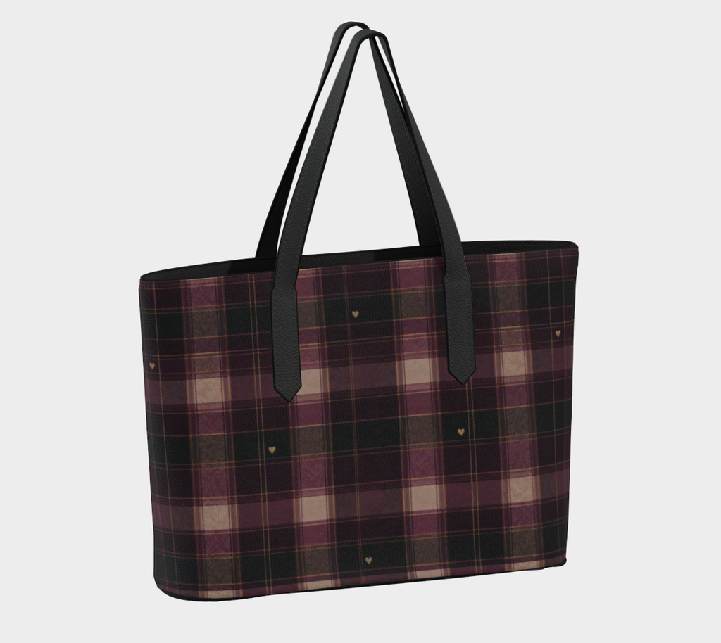 Opposite angle of plaid vegan leather tote showing tiny gold-colored hearts, black trim, and shoulder straps.