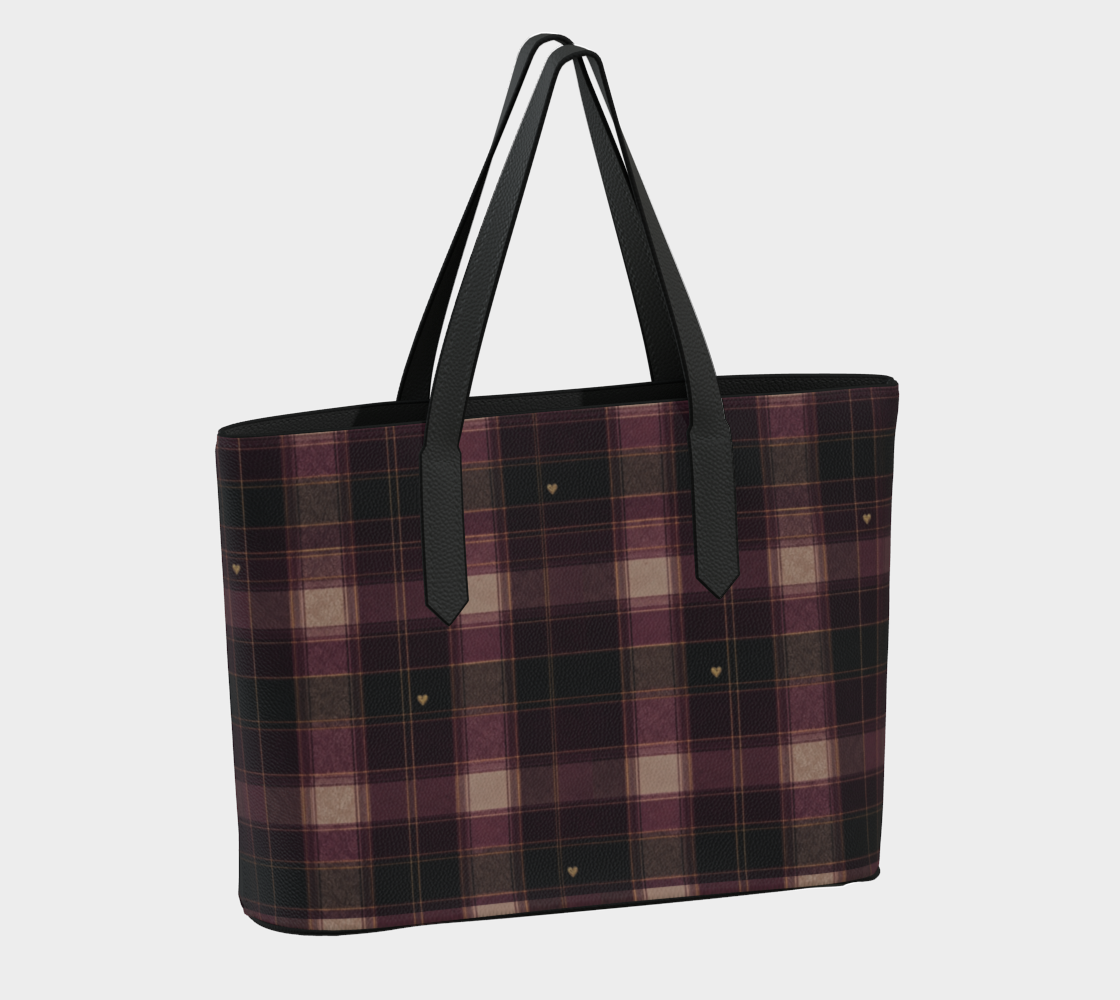 Opposite angle of plaid vegan leather tote showing tiny gold-colored hearts, black trim, and shoulder straps.