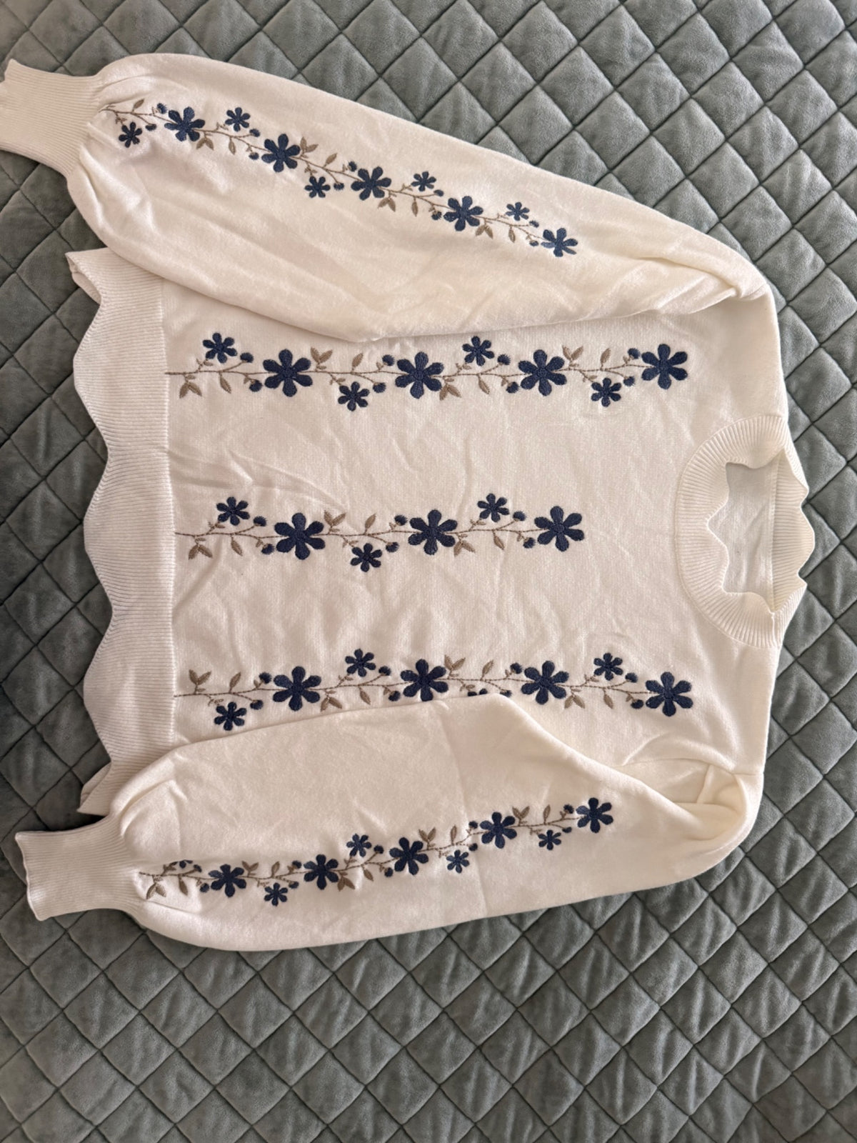 Becoming in Bloom cream sweater with navy floral embroidery shown in real life