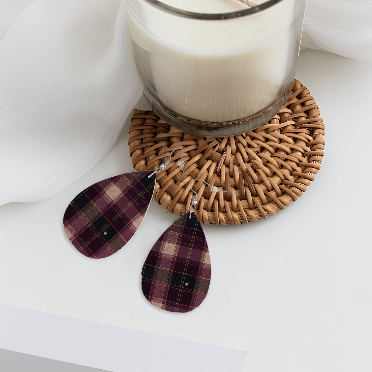 Plaid heart teardrop earrings styled beside a candle and woven coaster.