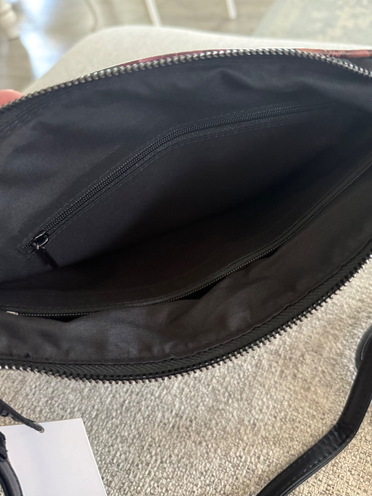 Interior of Falling For You floral crossbody showing dark lining and zip pocket