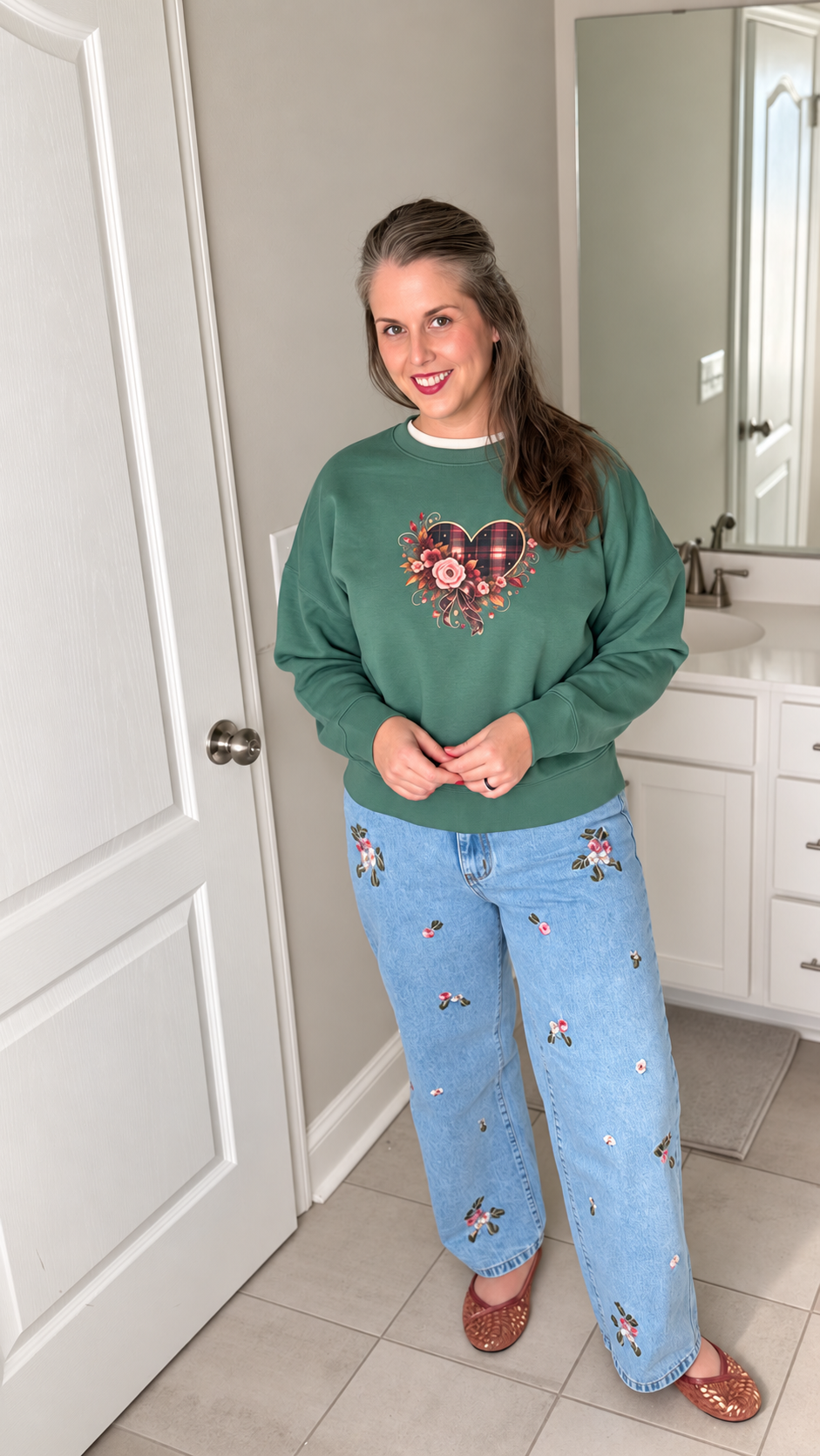 Jenny wearing Wildflower Embroidered Wide-Leg Jeans with the green Falling For You Plaid + Floral Organic Crewneck Sweatshirt.